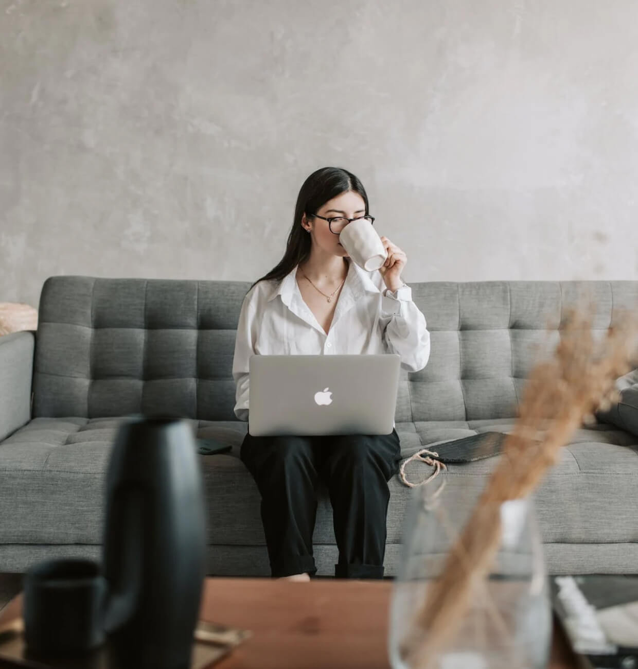 A woman working while having coffee